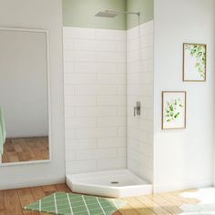 a bathroom with a shower, mirror and rug