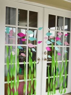 two doors decorated with paper fish and grass