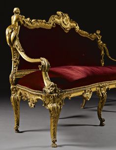 an ornately decorated gold and red couch