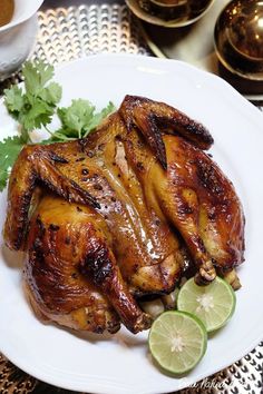 a white plate topped with chicken and garnished with cilantro