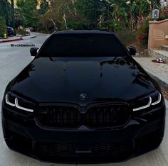 the front end of a black bmw car