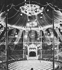 an old black and white photo of a stage with lots of lights on the ceiling