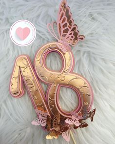 a pink and gold number with butterflies on it