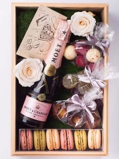 an open box filled with different types of food and drink on top of a table