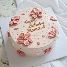 a birthday cake decorated with pink flowers and the words happy birthday mama written on it