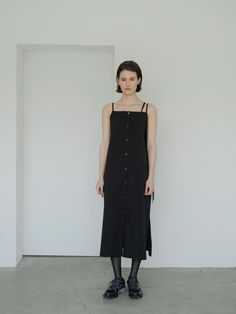 This is a trendy and unique dress by MORCEAU PAR MORCEAU that is made out of high quality and sturdy material. With distinctive mood of the design and feminine look, you can style it for your trendy and casual daily outfit.- Light and cool texture of the fabric- Adjustable shoulder strap- Slits on each side- Button closing detail Modern Black Maxi Dress For Work, Black Buttoned Midi Dress For Daywear, Black Midi Dress With Buttons For Daywear, Black Maxi Dress With Button Closure For Daywear, Modern Black Cotton Dresses, Modern Black Midi Dress For Daywear, Unique Dress, Button Dress, Feminine Look