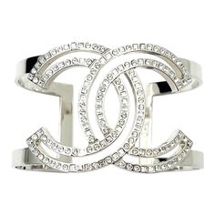 Chanel Classic Silver CC Square Round Crystal Cutout Double Cuff Bracelet  *Marked 17 *Made in Italy *Comes with the original box and pouch  -Approximately 1.5″ width, 6″ circumference( without the gap), 1.25″ open gap -Very stylish and classic -In a pristine condition  AB4157-00318  Please see the measurements section for best approximate dimensions. Luxury Silver Open Cuff Bracelet, Designer White Gold Cuff Bracelet For Formal Occasions, Luxury White Gold Cuff Bracelet, Chic Silver Cuff Bracelets, Modern Silver Cuff Bracelet For Evening, Designer Silver Bracelets For Party, Luxury Open Cuff Bracelet As Gift, Chic Silver Cuff Bangle, Luxury White Gold Cuff Bracelet Gift