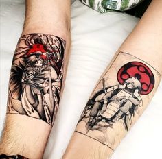 two people with tattoos on their arms sitting next to each other