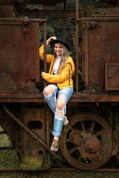 a woman sitting on the side of an old train