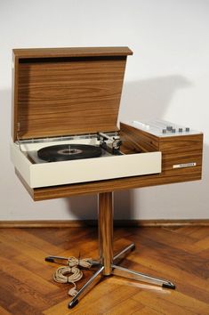 a record player sitting on top of a wooden table