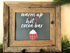 a framed sign that says warm up, hot cocoa bar