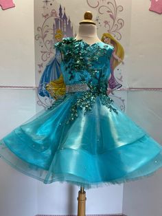 Blue Embellished Princess Dress For Party, Blue Embellished Princess Dress For Dress-up, Embellished Blue Princess Dress For Dress-up, Fitted Blue Princess Dress With Floral Applique, Blue Pageant Dress For Spring, Blue Spring Pageant Dress, Blue Sequin Dress For Dress-up, Fitted Blue Sequined Pageant Dress, Elegant Green Pageant Dress For Party