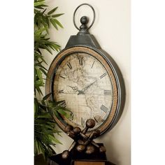 an old world map clock on top of a shelf