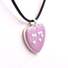 Choose any 1-2 letters in braille on this cute heart shaped pendant. The necklace is made out of polymer clay in a silver-tone pendant cup with your choice of clay color. It comes with a choice of silver plated chain or leather cord (18-20 inches) and white or black metal dots. The pendant is sealed with a coat of glaze. The flower measures 1-1/2 inches tall (38mm) including bail/loop 1-1/8 inches across (28 mm) This example is made of light, bright purple clay but can be made in any color you c Clay Color, Heart Shaped Pendant, Inspired Necklace, Light Bright, Cute Heart, Heart Shape Pendant, Bright Purple, Freshwater Pearl Necklaces, 1 Or 2