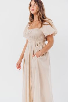 Be the life of the party in the Nan Maxi Dress! This beautiful gown comes in a gorgeous, multi-season neutral hue, and features a smocked bodice and puffed sleeves that can be worn on or off the shoulder - it's like getting two dresses in one! Style the Nan with slides for a casual, feminine outfit, or with neutral heels for the perfect event dress. FIT: Runs true to size. MATERIAL: GARMENT DETAILS: Neutral maxi dress with empire waist silhouette, smocked bodice, and puffed sleeves with elastica Neutral Maxi Dress, Dress With Puffed Sleeves, Smocked Maxi Dress, Neutral Heels, Garment Details, Event Dress, Life Of The Party, Feminine Outfit, Puffed Sleeves