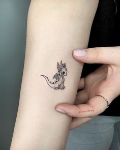 a woman with a small tattoo on her arm