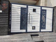 an entrance to a building with decorative designs on the door and side panels, in front of a stone wall