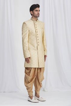 Beige sherwani in art banarasi silk base fabric featuring embroidered floral motifs, collar and shank buttons. Paired with dhoti pant.
Component: 2
Embroidered
Neckline: Mandarin
Sleeve Length: Full
Fabric: Sherwani: Art Banaras Silk; Dhoti: Dupion Art Silk; Lining: Faux Satin
Color: Beige
Embroidered button details
Side button panel
Embroidered collar
Potli button details
Elasticated and drawstring waistband
Note: The pocket square worn by the model is not for sale - Aza Fashions Potli Button, Embroidered Sherwani, Dhoti Pants, Embroidered Collars, Embroidered Neckline, Satin Color, Fashion App, Pant Set, Drawstring Waistband