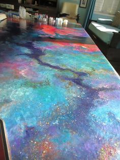 the counter top is covered in multicolored paint