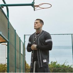 a man standing in front of a basketball hoop