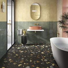 a bath room with a tub a sink and a mirror on the wall next to a plant