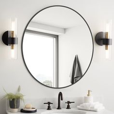 a bathroom sink with a round mirror above it