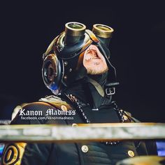 a man wearing a gas mask with his head in the air and looking at something behind him