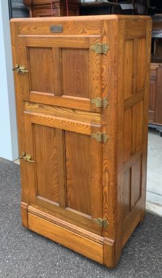 an old wooden cabinet is sitting on the ground