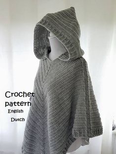 a crochet hooded ponchy is shown in grey