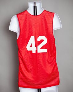 "Reversible red and white basketball jersey tank. One side red and one side white. Number 42 on the back. Alleson Athletic size - S laying folate: pit to pit - 18.5\" vintage pre-owned" College Team Spirit Sleeveless Jersey, Sleeveless College Jersey With Team Spirit Style, Sleeveless Collegiate Jersey For Game Day, Collegiate Sleeveless Jersey For Team Events, Collegiate Sleeveless Jersey For Sports Events, Collegiate Sleeveless Sports Jersey, Collegiate Style Sleeveless Jersey For Sports Events, Sporty Sleeveless College Jersey, Sleeveless Basketball Jersey With Team Name