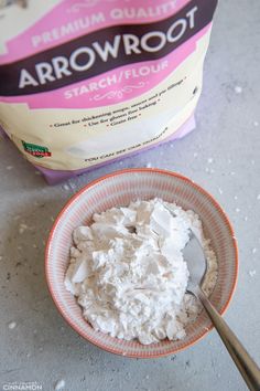 a bowl filled with white powder next to a bag of arrowroot