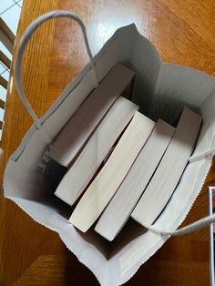 an open book bag sitting on top of a wooden table