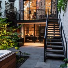 an apartment building with stairs leading up to the upper floor