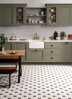 an advertisement for a kitchen with green cabinets and white tile flooring in the background