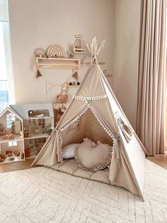 a child's teepee is set up on the floor