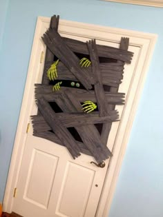 a door decorated with fake hands and green eyes