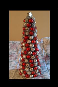 a christmas tree made out of silver and red ornaments