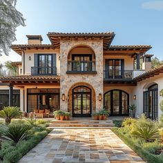 a large house with lots of windows and plants