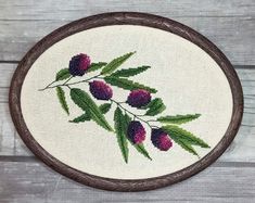 a cross stitched picture of flowers on a white background