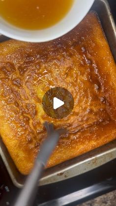 a pan filled with food next to a bowl of liquid on top of a stove