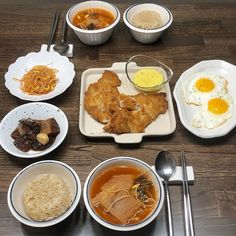 a table topped with bowls and plates filled with different types of food on top of it