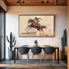 a dining room table with four chairs and a painting hanging on the wall above it