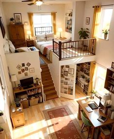 an aerial view of a living room and bedroom from the second floor, looking down