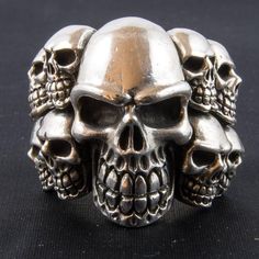 *  This 11 skull cluster is brilliant    Just look at the expressions on these skulls.*  Hand made in our workshops in Devon*  Around 2.3 ounce of .925 fully hall marked sterling silver ring    Approx. 20mm from top to bottom*  Available in P - Z*  Special Sizes are available on request Silver Skull Ring Collectible, Collectible Silver Gothic Skull Ring, Collectible Gothic Silver Skull Ring, Collectible Silver Skull Jewelry, Biker Silver Skull Jewelry, Silver Gothic Skull Ring Collectible, Silver Skull Biker Jewelry, Hallmarked Sterling Silver Skull Ring, Sterling Silver Skull Ring Hallmarked