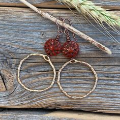 Gold Plated Hammered Hoop Earrings with a Red Czech Glass Flower. Includes Nickel Free Ear Wires. These earrings are light weight, comfortable, simple and fun. Throw them on with any outfit and they will definitely add some pop! They are approximately 2.75 inches in length and 1.25 inches at the widest portion. If you would like these in a different color or size, please let me know as I also do custom orders. To view more of my original jewelry designs, visit: https://www.etsy.com/shop/TheBeadC Handmade Adjustable Rust Earrings, Bohemian Rust Earrings With Ear Wire, Rust Bohemian Earrings For Pierced Ears, Handmade Nature-inspired Round Hoop Earrings, Red Bohemian Circular Jewelry, Red Round Flower Earrings With Ear Wire, Handmade Nature-inspired Hoop Earrings, Red Brass Earrings With Ear Wire, Red Wire Wrapped Hoop Earrings