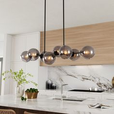 a modern kitchen with marble counter tops and wooden cabinets