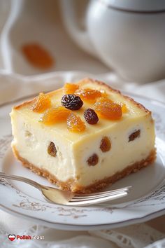 a piece of cheesecake with raisins on top sits on a white plate