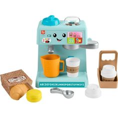 a toy coffee maker with cups and spoons