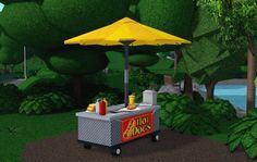 a hot dog cart sitting on top of a lush green park