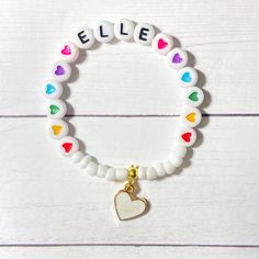 This colorful heart bracelet makes a great birthday gift! The white beads and heart charm make the heart beads pop! Personalize this bracelet for someone you love ❤️ The bracelets are beautifully packaged and ready to gift. Receipts are never included in your package. If you want to include a special note, please let me know in the comments. Roll, don't pull. To avoid excess stretching please roll the bracelet on and off. Treat and store the bracelets gently. Sizing options are just a guideline. Playful Heart-shaped Letter Beads Bracelet, Birthday Heart Charm Bracelet, Cute Heart-shaped Charm Bracelet With Heart Beads, White Heart Stretch Bracelet For Valentine's Day, Cute Heart Beads Charm Bracelet, White Heart-shaped Stretch Bracelet For Valentine's Day, Playful Heart Beads Bracelet For Gift, Playful Heart Beads Bracelet For Gifts, Friendship Heart Bracelet With Letter Beads